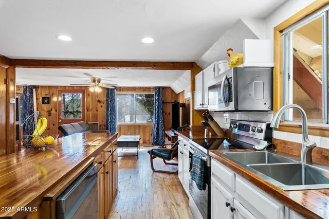 a kitchen with stainless steel appliances a sink and cabinets