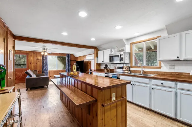 a kitchen with counter top space a sink cabinets and appliances