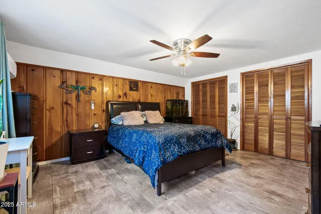 a bedroom with a large bed and a chandelier