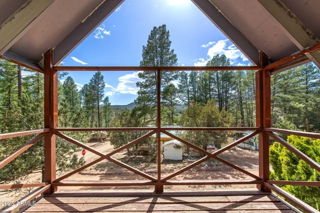 a view of a balcony with chairs and wooden floor