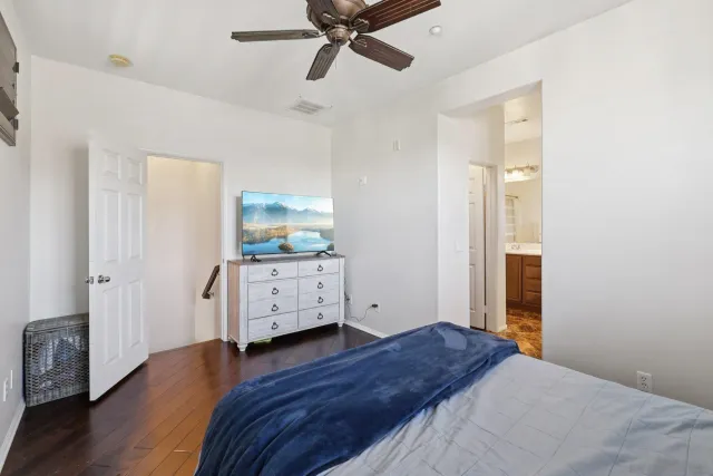 a bedroom with a bed and a flat tv screen