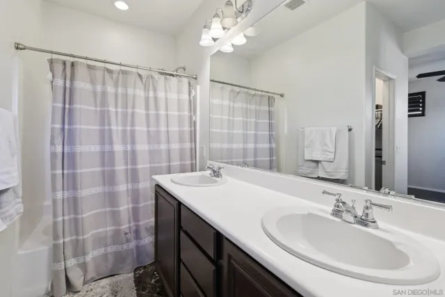 a bathroom with a sink double vanity and a shower