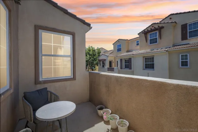a balcony with table and chairs