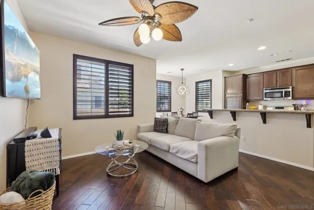 a living room with kitchen island furniture and a wooden floor