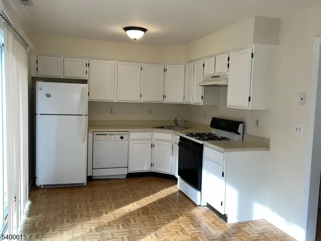 a kitchen with cabinets appliances and a counter space