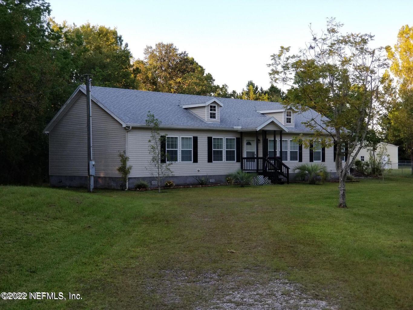 54366 Hurst Road Callahan, FL 32011 - Photo 1 of 1 a front view of a house with a garden