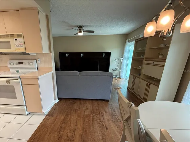 a kitchen with a sink a refrigerator and cabinets