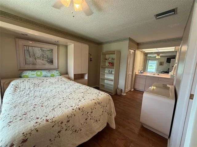 a bedroom with a bed window and a chandelier