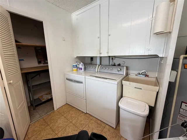 a utility room with closet dryer and washer