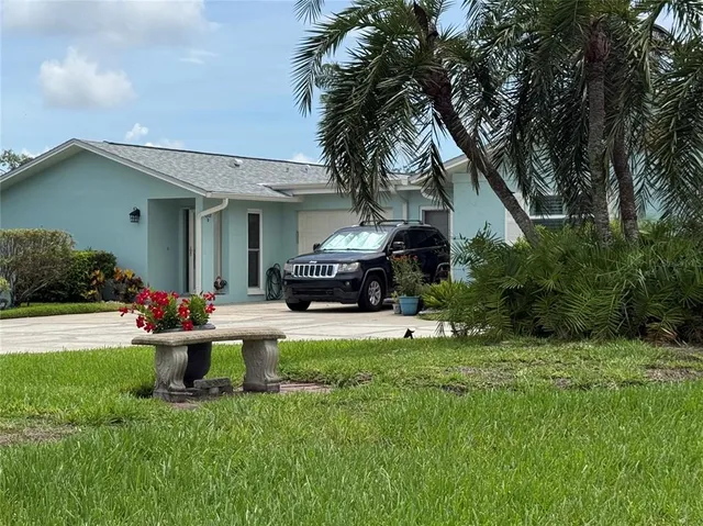 a front view of a house with a garden and yard