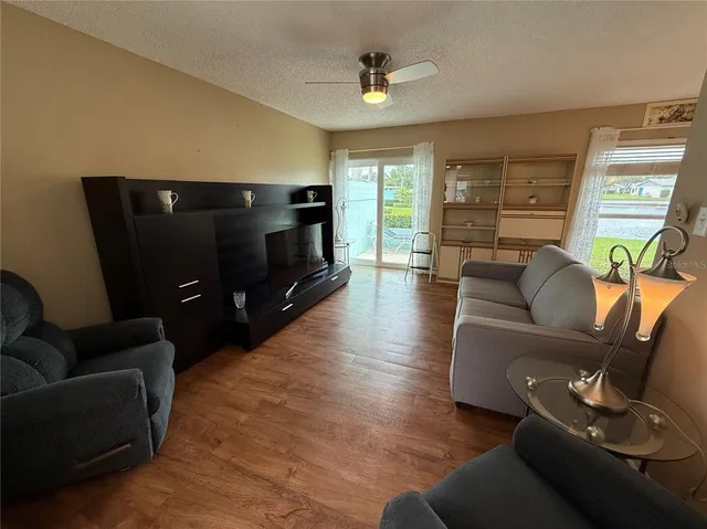 a view of a hallway to rooms and wooden floor