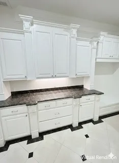 a kitchen with granite countertop white cabinets and sink