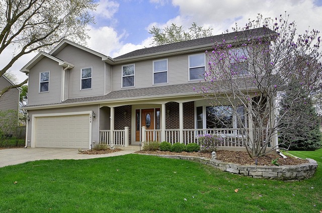 1616 South Tyler Road St. Charles, IL 60174 - Photo 1 of 25 a front view of a house with a garden and plants
