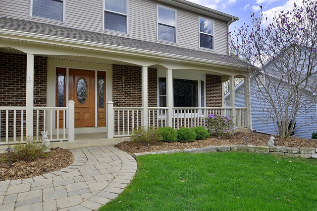1616 South Tyler Road St. Charles, IL 60174 - Photo 2 of 25 a view of a brick house with a yard plants and large tree