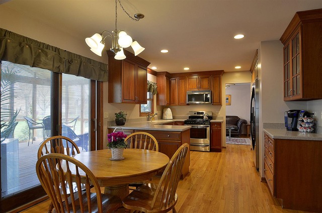 1616 South Tyler Road St. Charles, IL 60174 - Photo 5 of 25 a kitchen with stainless steel appliances granite countertop a refrigerator a stove top oven a sink dishwasher a dining table and chairs with wooden floor