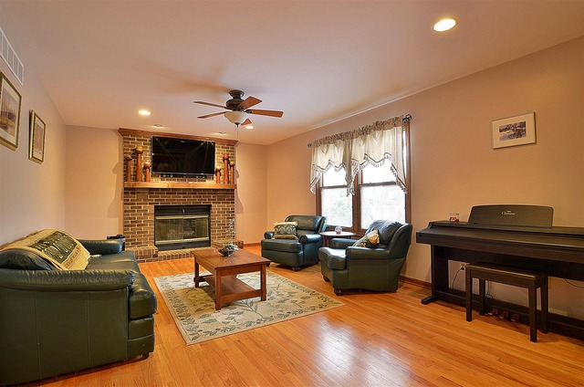 1616 South Tyler Road St. Charles, IL 60174 - Photo 8 of 25 a living room with furniture a fireplace and a flat screen tv