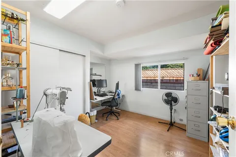 a view of a bedroom with workspace and bedroom