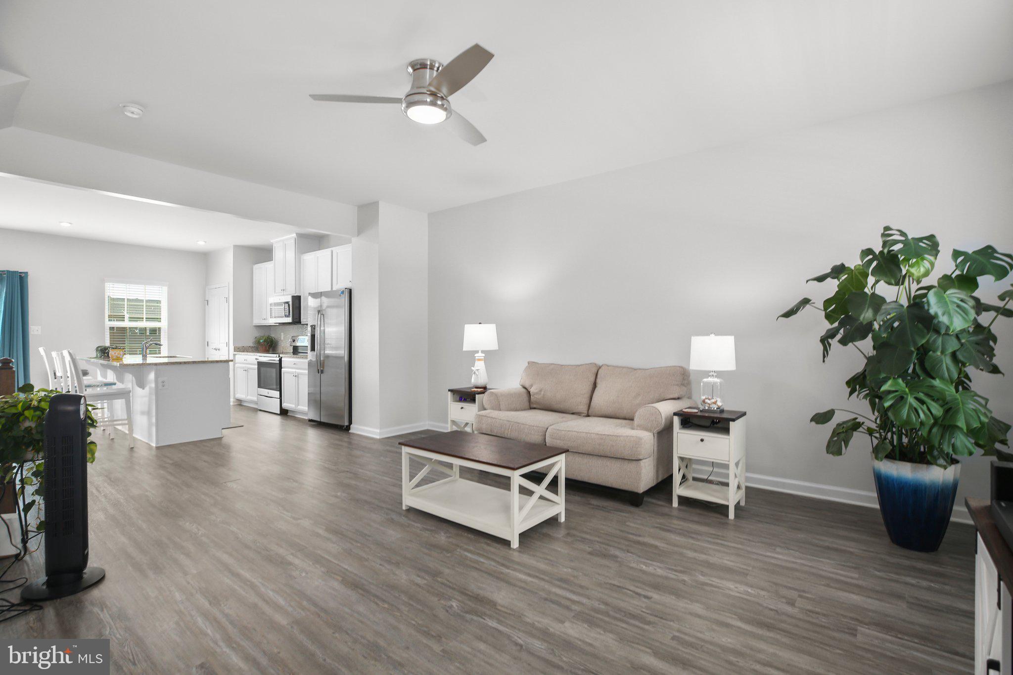 8410 Devries Lane Spotsylvania, VA 22553 - Photo 12 of 32 a living room with furniture potted plant and kitchen view