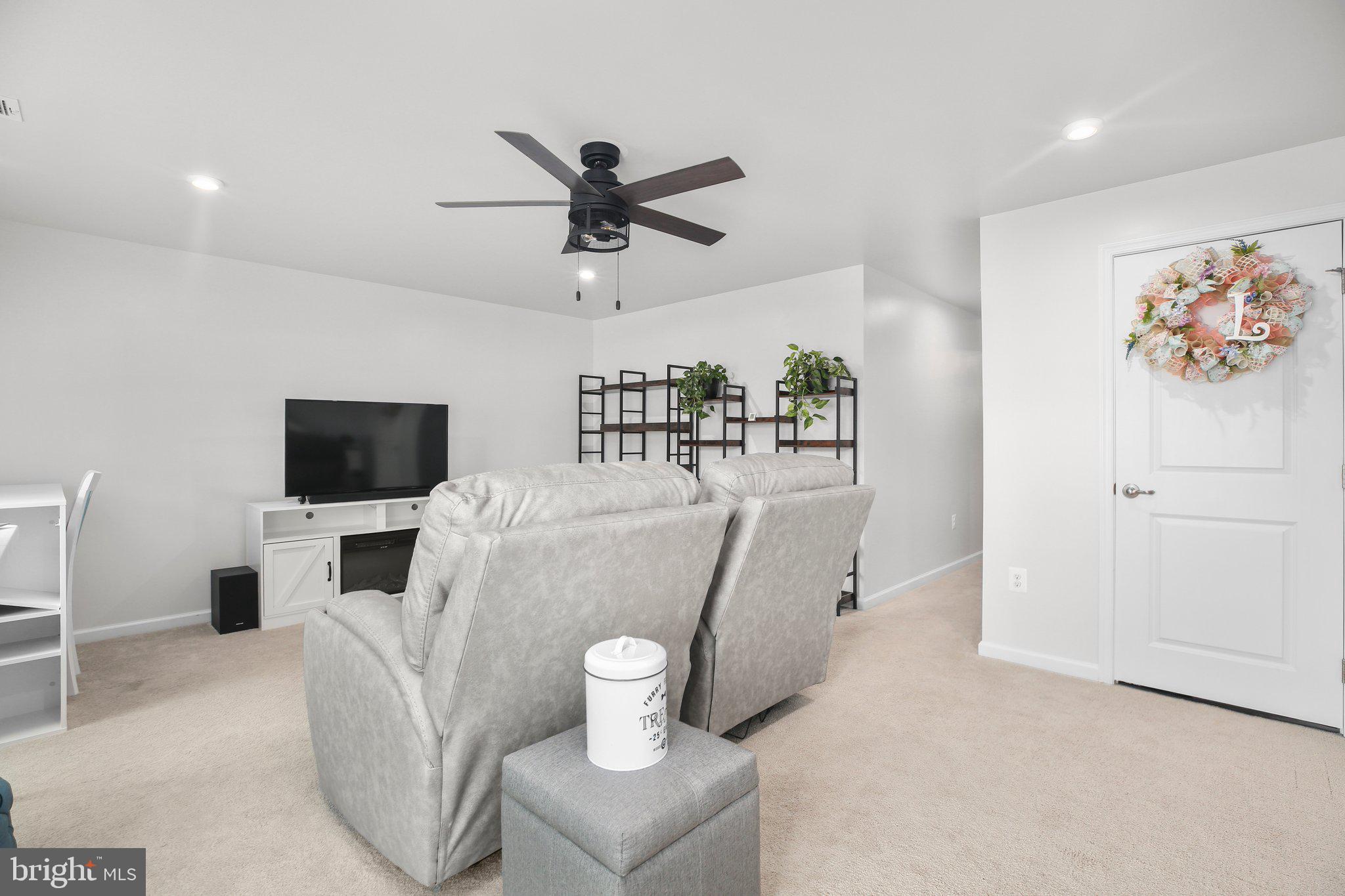 8410 Devries Lane Spotsylvania, VA 22553 - Photo 15 of 32 a living room with furniture and a flat screen tv
