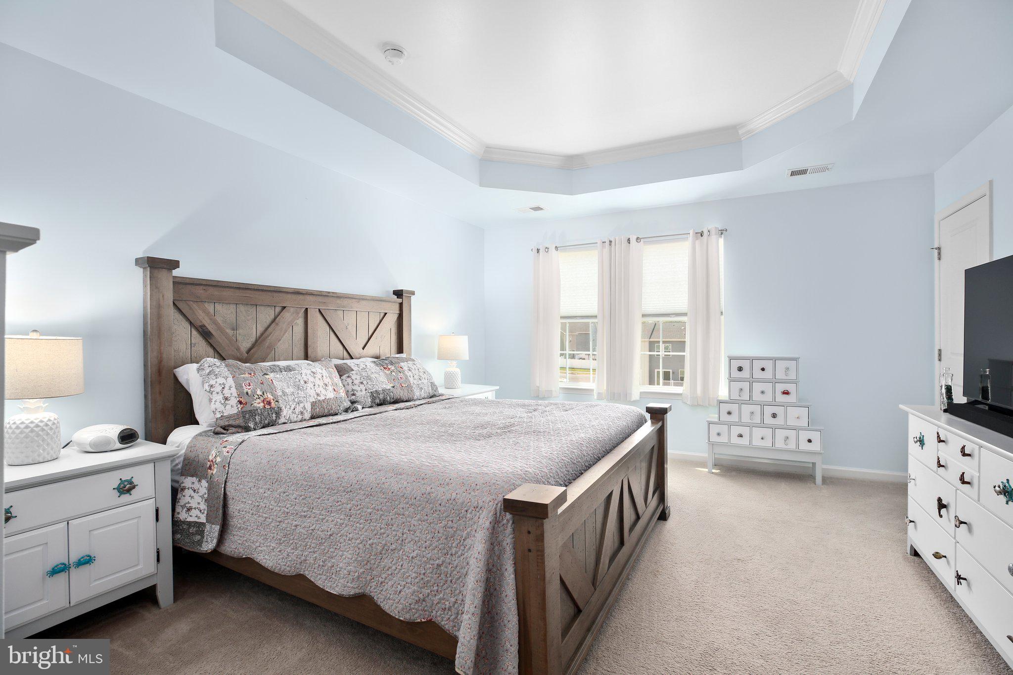 8410 Devries Lane Spotsylvania, VA 22553 - Photo 17 of 32 a bedroom with a bed and a flat tv screen on dresser