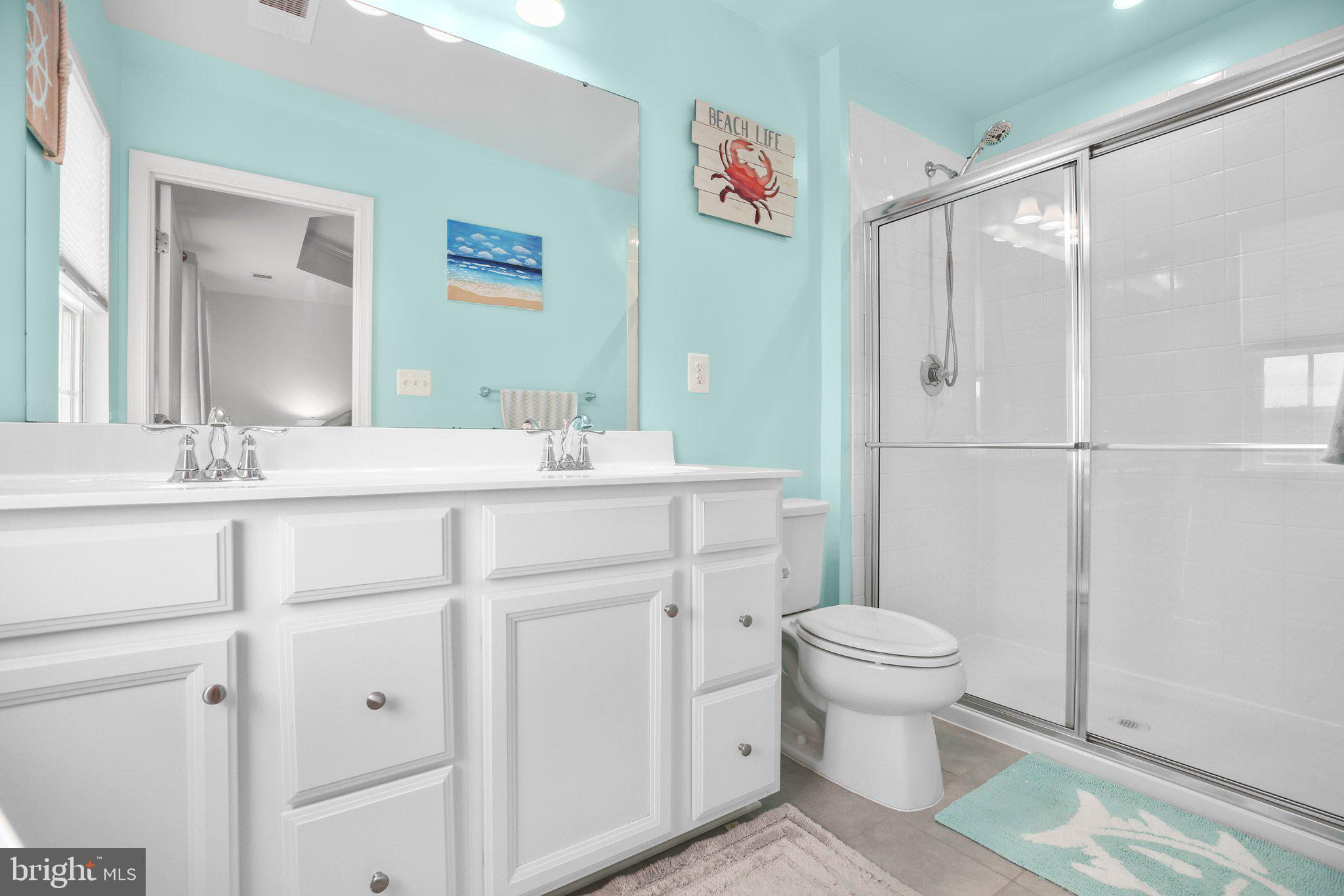 8410 Devries Lane Spotsylvania, VA 22553 - Photo 20 of 32 a bathroom with a sink toilet vanity and shower