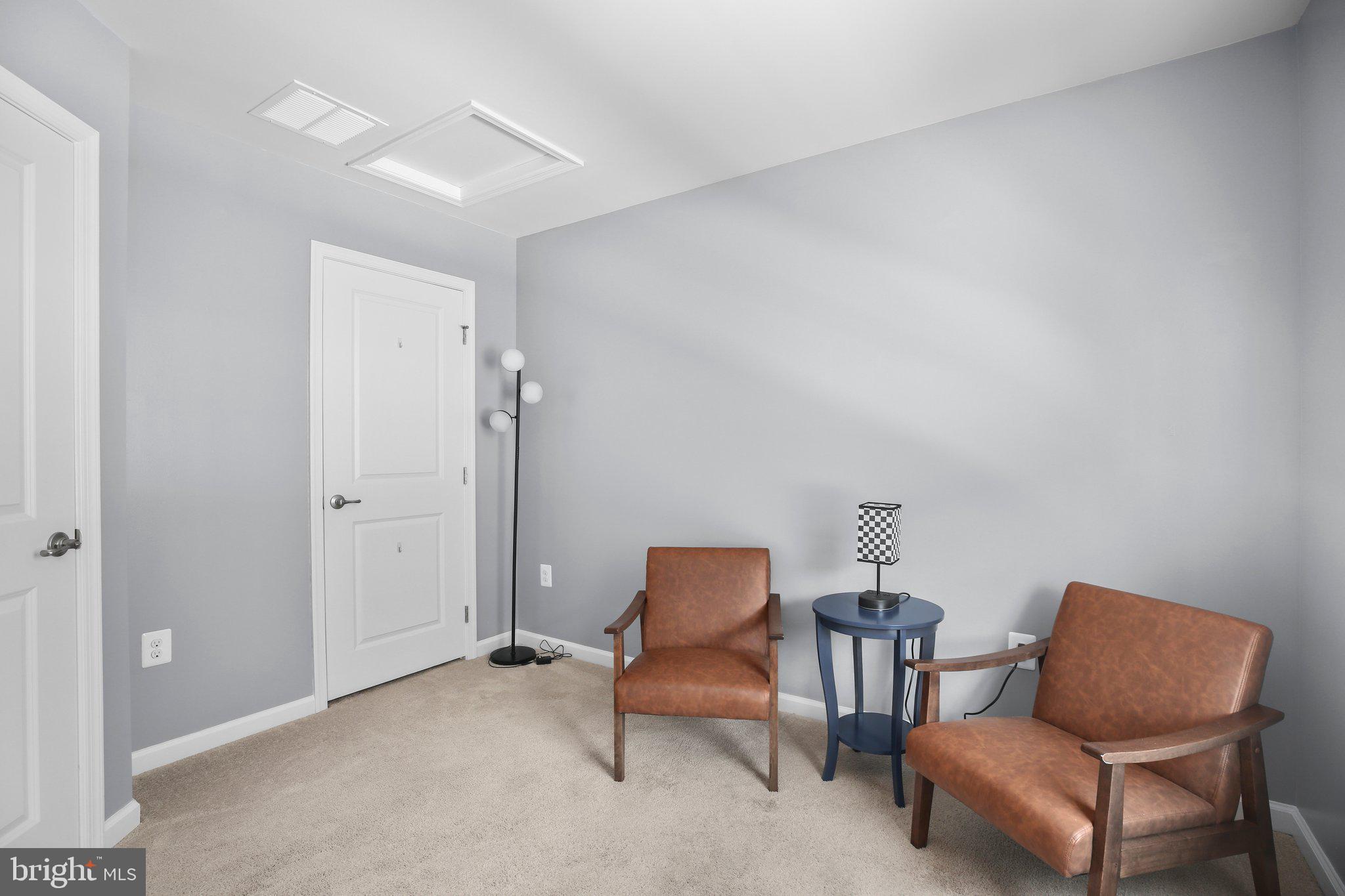 8410 Devries Lane Spotsylvania, VA 22553 - Photo 25 of 32 a blue chair sitting in a room next to a chair