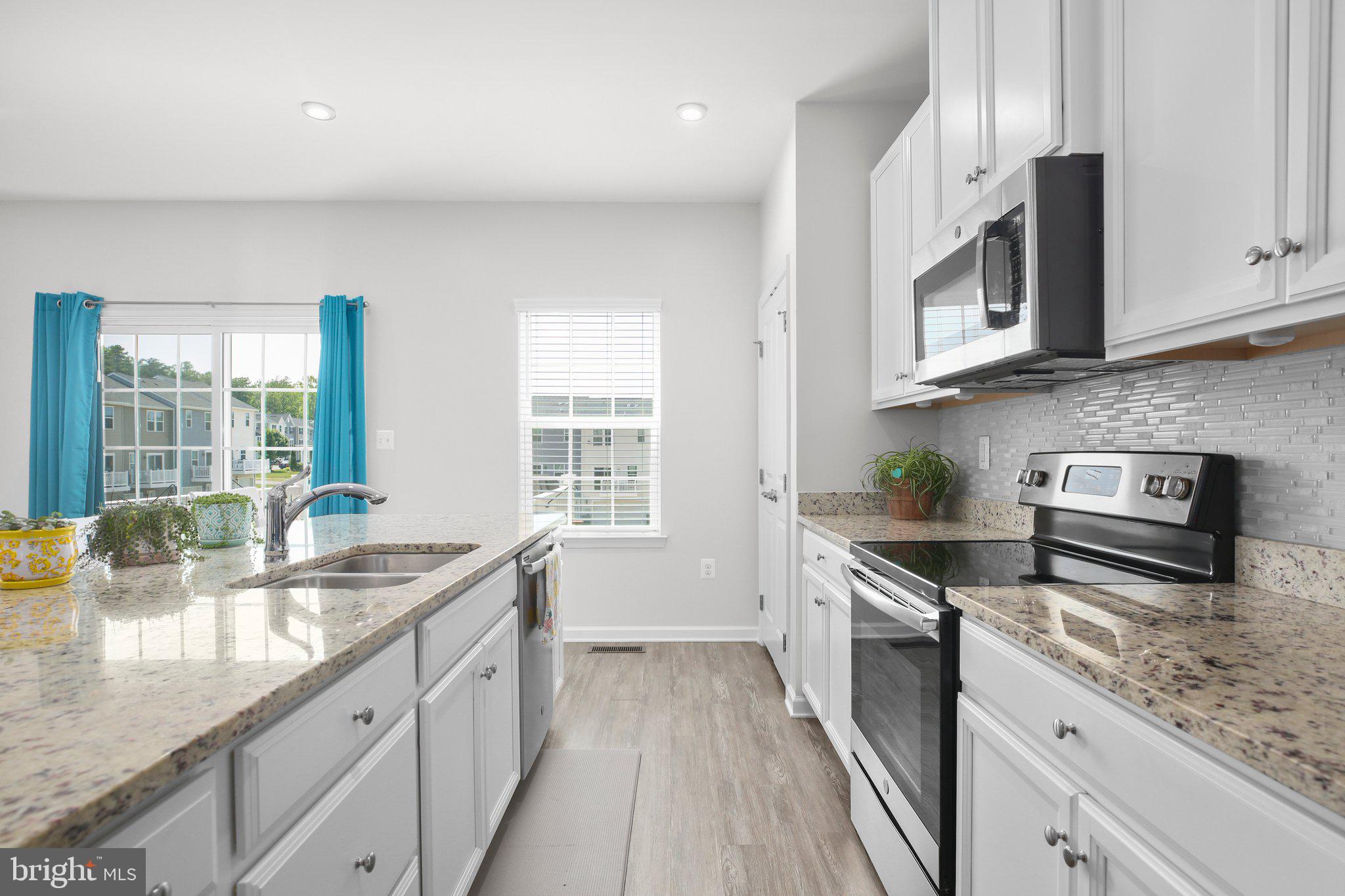 8410 Devries Lane Spotsylvania, VA 22553 - Photo 5 of 32 a kitchen that has a sink and a stove