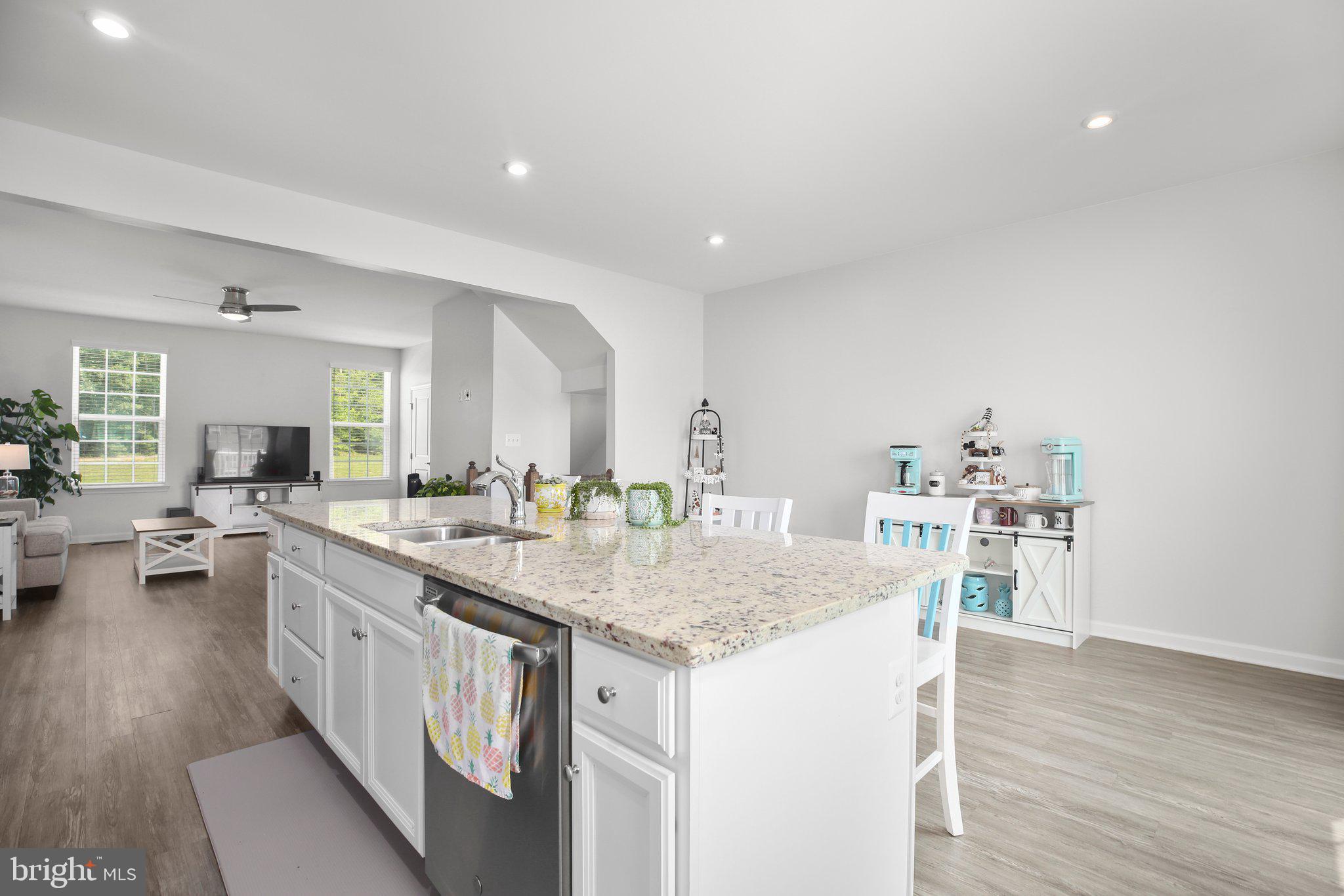 8410 Devries Lane Spotsylvania, VA 22553 - Photo 6 of 32 a kitchen with a stove and white cabinets