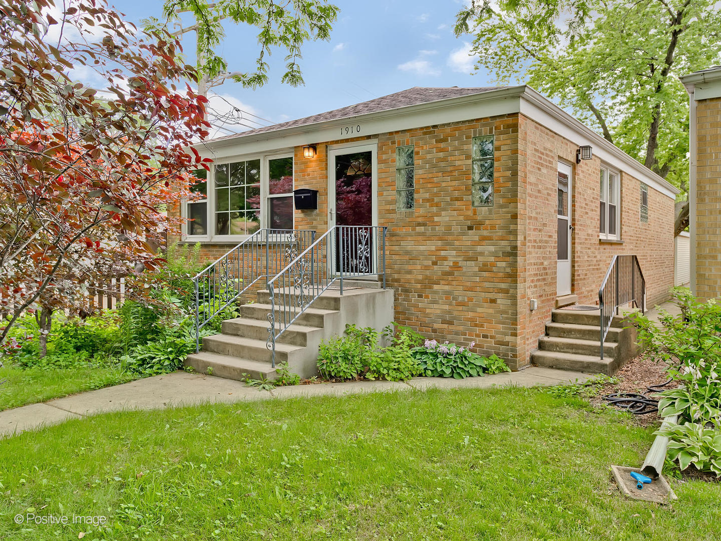 1910 Warren Street Evanston, IL 60202 - Photo 2 of 22 a front view of a house with a garden