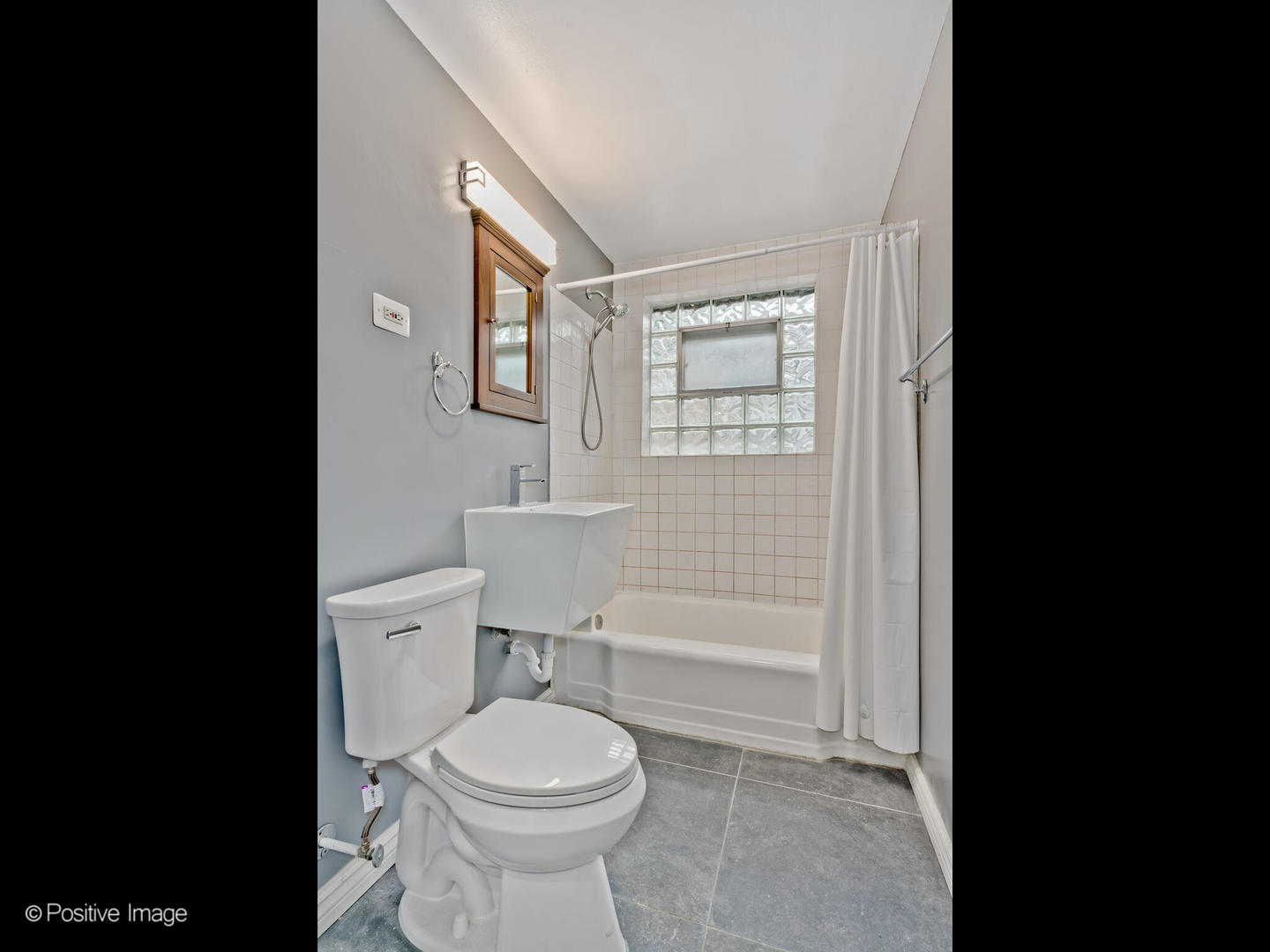 1910 Warren Street Evanston, IL 60202 - Photo 11 of 22 a bathroom with a toilet a sink and mirror