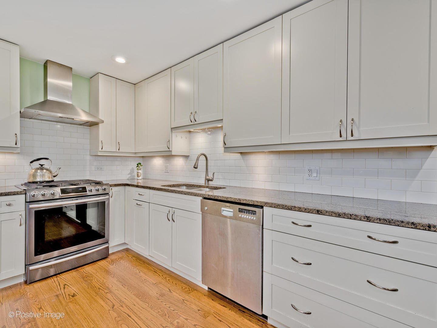 1910 Warren Street Evanston, IL 60202 - Photo 8 of 22 a kitchen with granite countertop white cabinets and stainless steel appliances