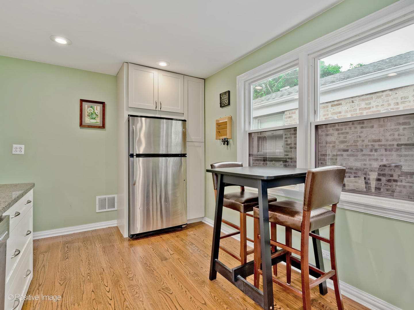 1910 Warren Street Evanston, IL 60202 - Photo 9 of 22 a kitchen with stainless steel appliances granite countertop a table chairs and a refrigerator