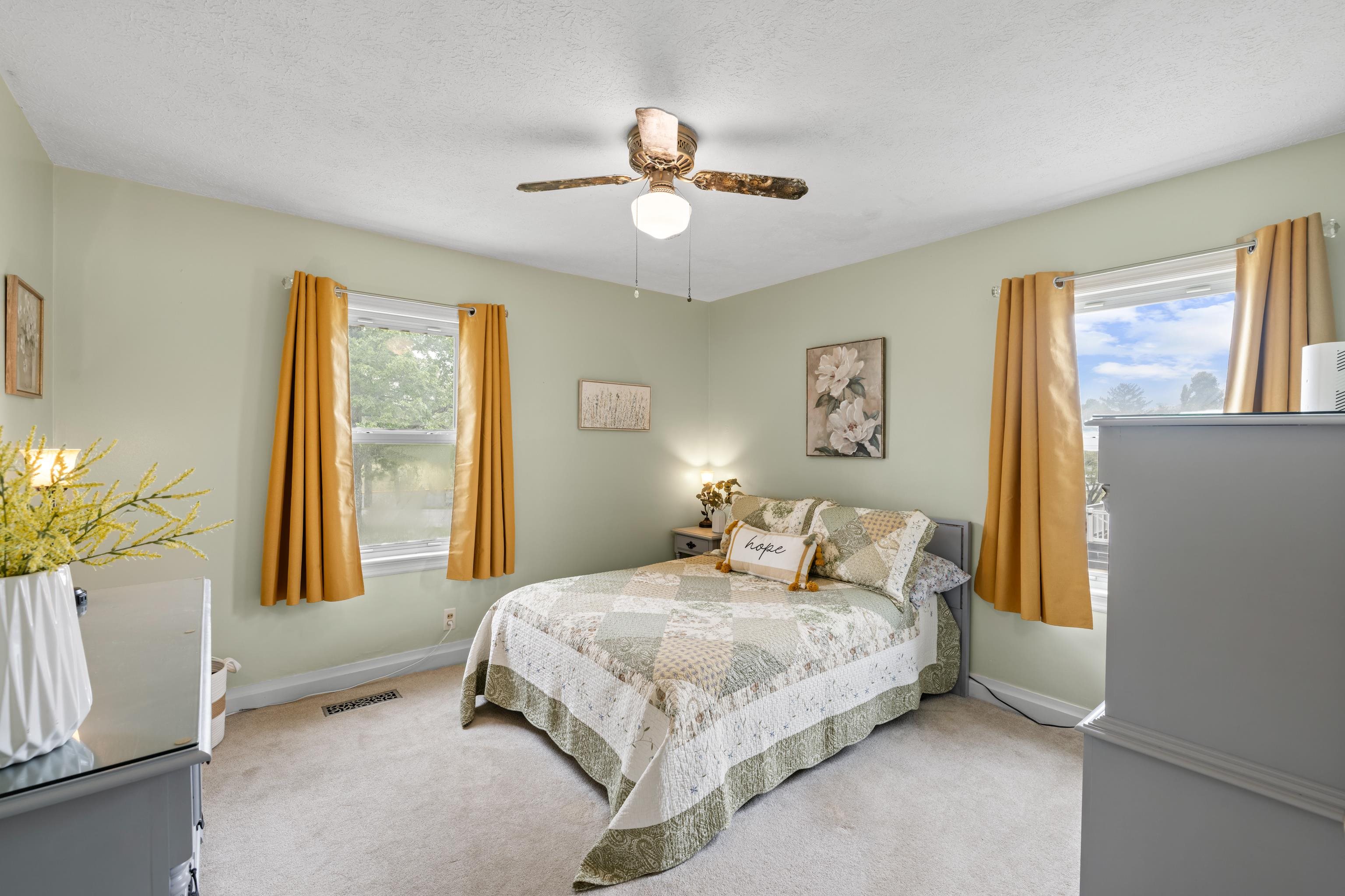118 Stuart Avenue Stuarts Draft, VA 24477 - Photo 23 of 61 a bedroom with a bed and a chandelier