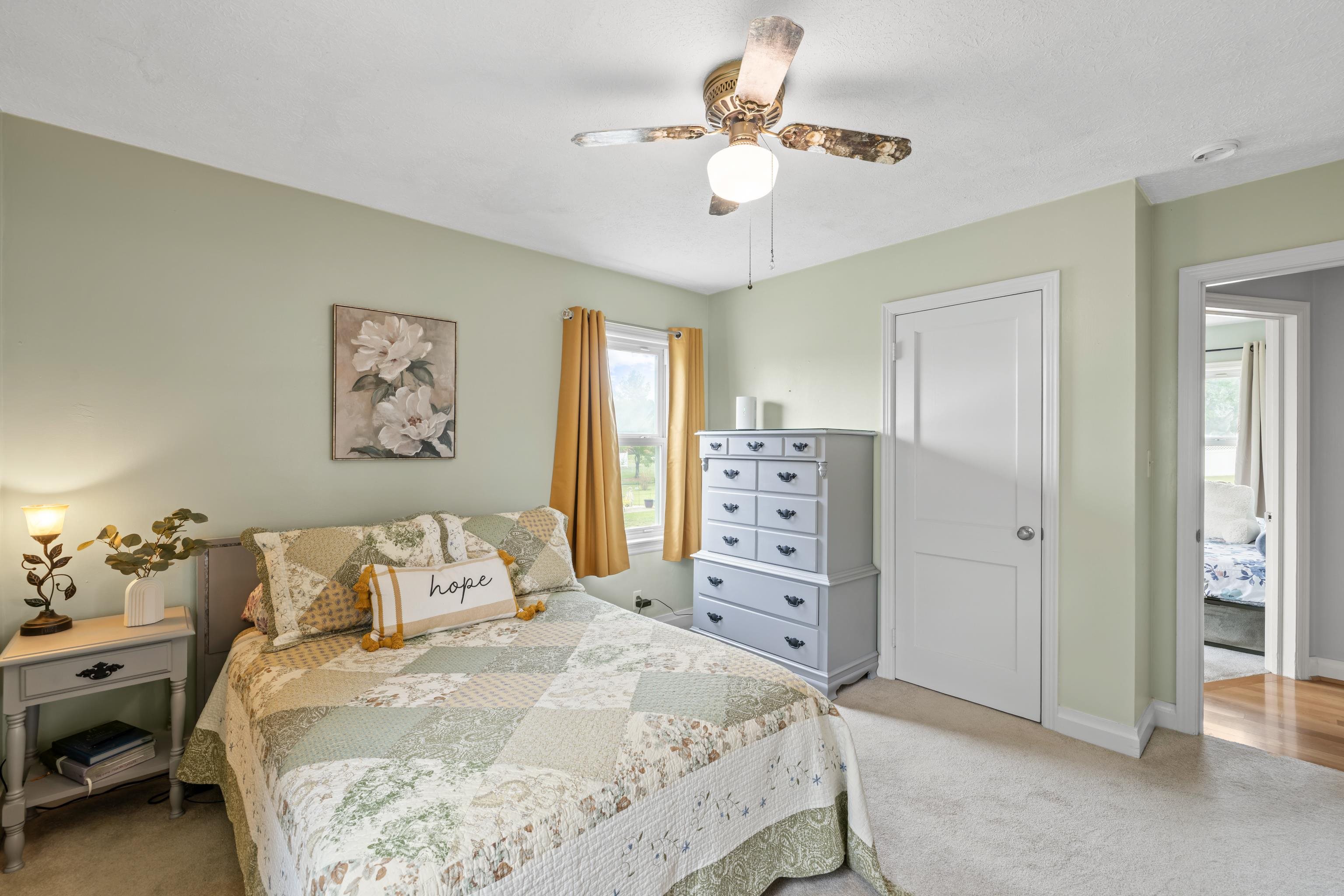 118 Stuart Avenue Stuarts Draft, VA 24477 - Photo 24 of 61 a bedroom with a bed and a chandelier