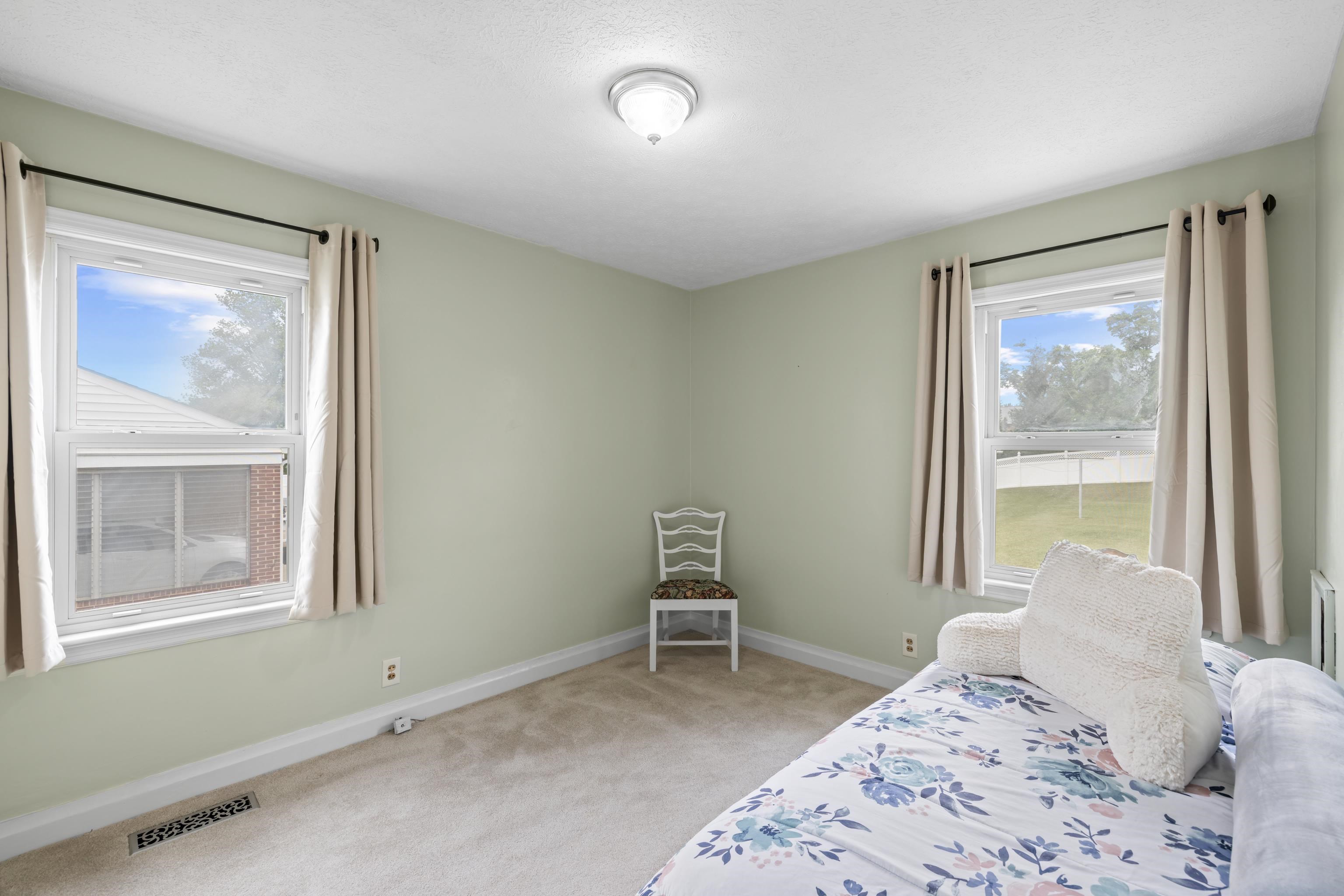 118 Stuart Avenue Stuarts Draft, VA 24477 - Photo 29 of 61 a bedroom with a bed and a window