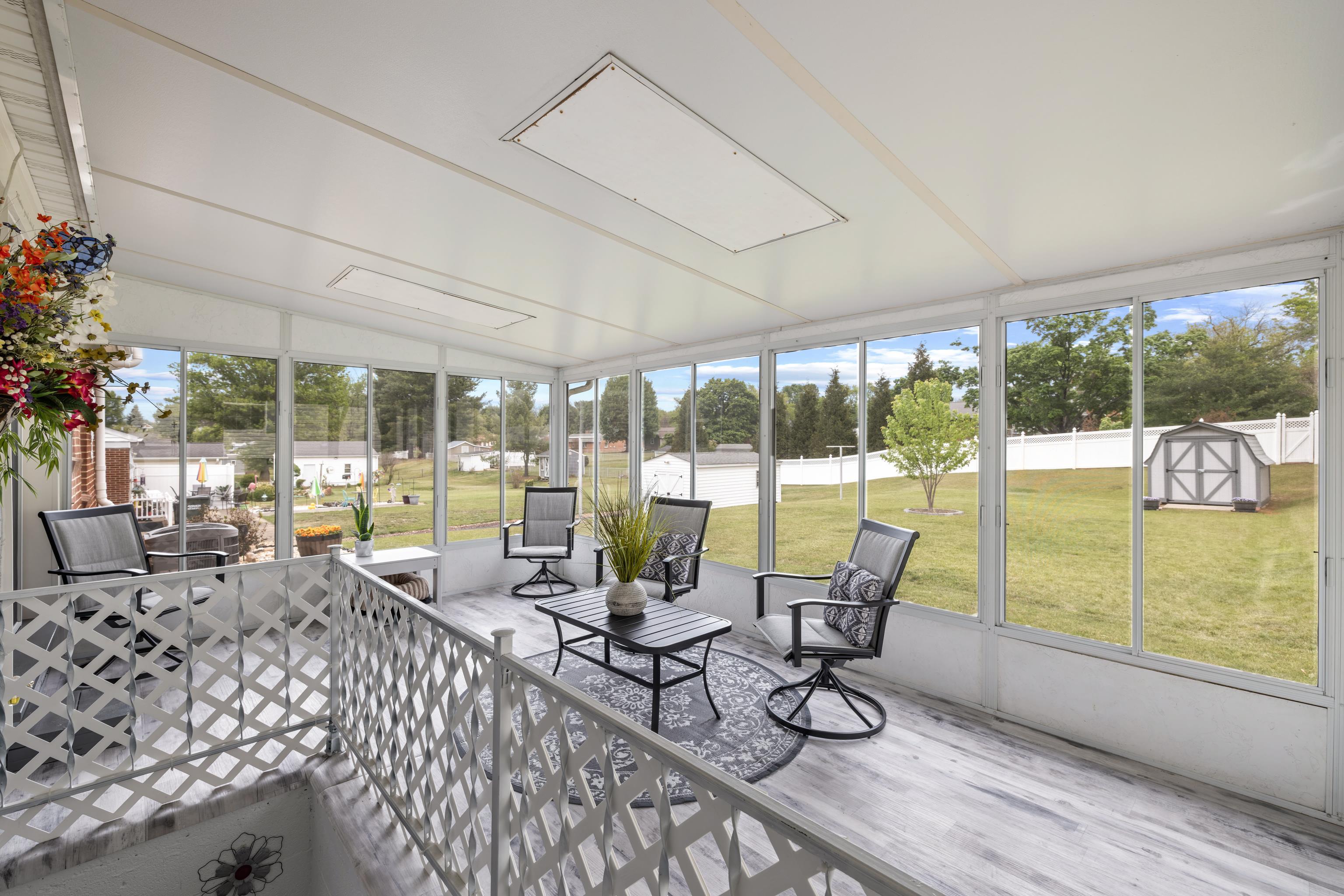 118 Stuart Avenue Stuarts Draft, VA 24477 - Photo 32 of 61 a living room with furniture and floor to ceiling windows