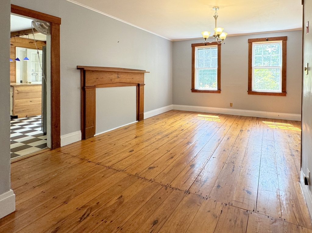 6 Pine Street Northfield, MA 01360 - Photo 22 of 42 a view of an empty room with wooden floor and a window