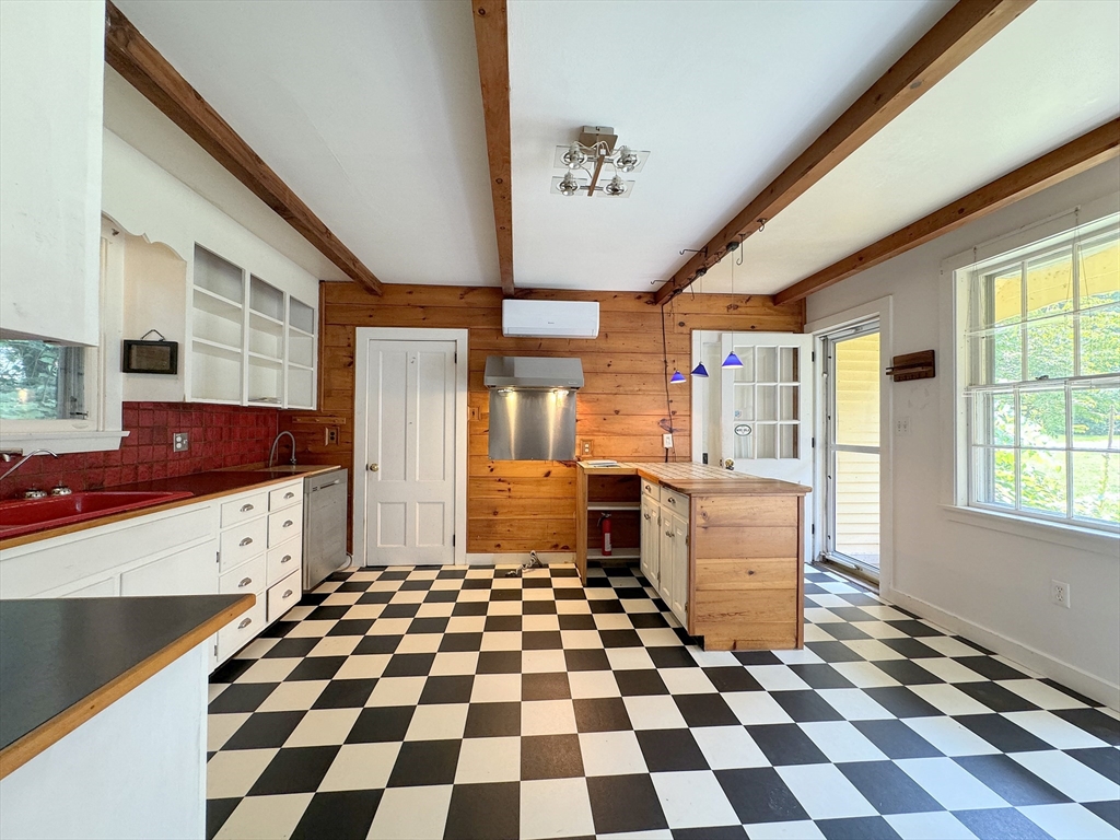 6 Pine Street Northfield, MA 01360 - Photo 23 of 42 a kitchen with a checkered floor and white cabinets