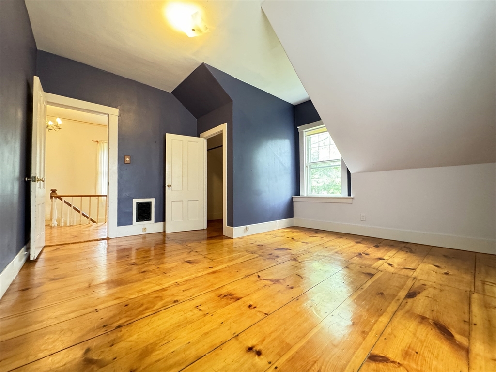 6 Pine Street Northfield, MA 01360 - Photo 31 of 42 a view of an empty room with wooden floor and windows