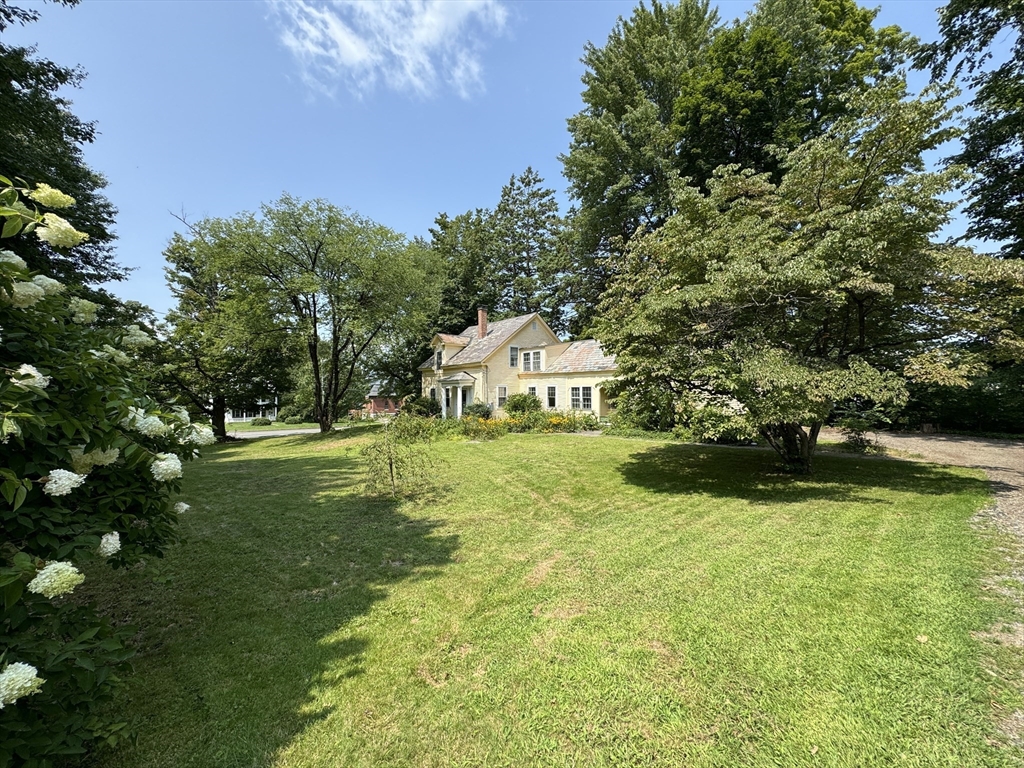 6 Pine Street Northfield, MA 01360 - Photo 6 of 42 a yellow house with garden in front of it