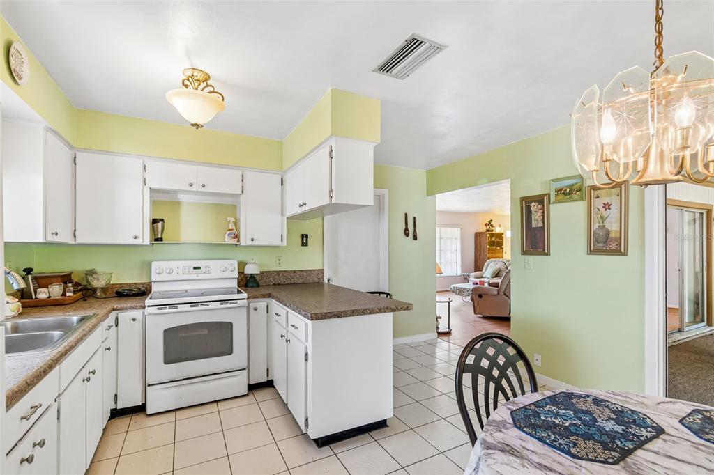 2059 Waterfall Drive Spring Hill, FL 34608 - Photo 8 of 26 a kitchen with a sink stove and cabinets
