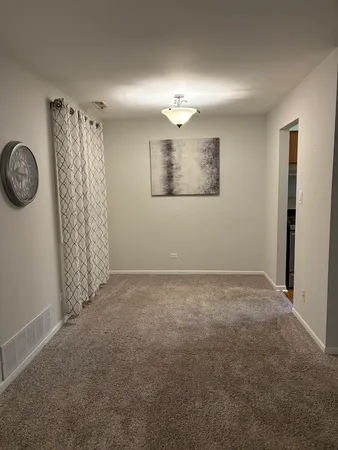 a view of an empty room with a fan