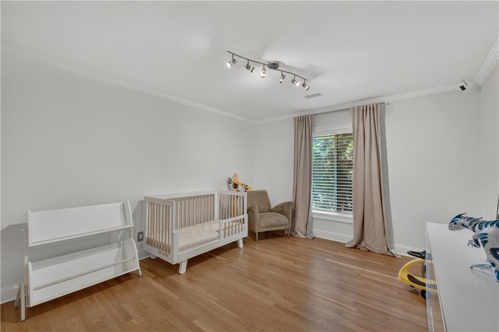 4610 West Morton Road Alpharetta, GA 30022 - Photo 19 of 53 a spacious bedroom with a bed and a window