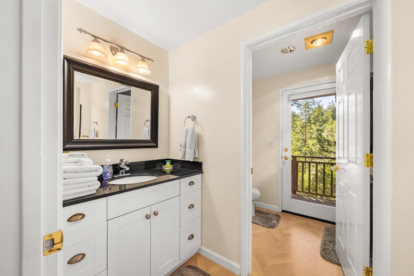 2000 Glen Canyon Road Santa Cruz, CA 95060 - Photo 31 of 41 a bathroom with a granite countertop sink a mirror and a window