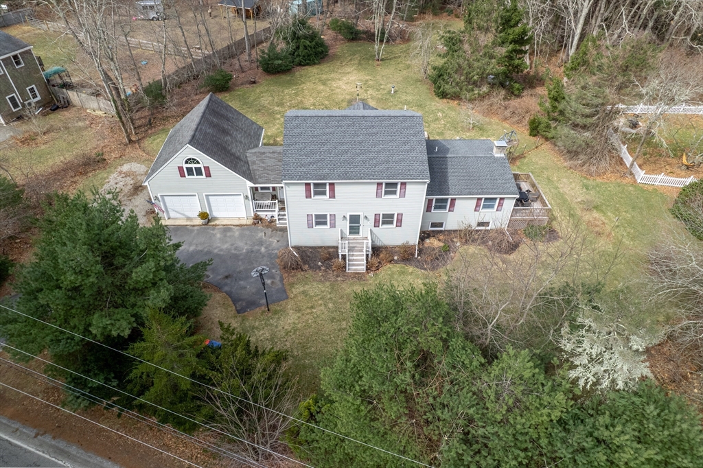 an aerial view of a house with a yard