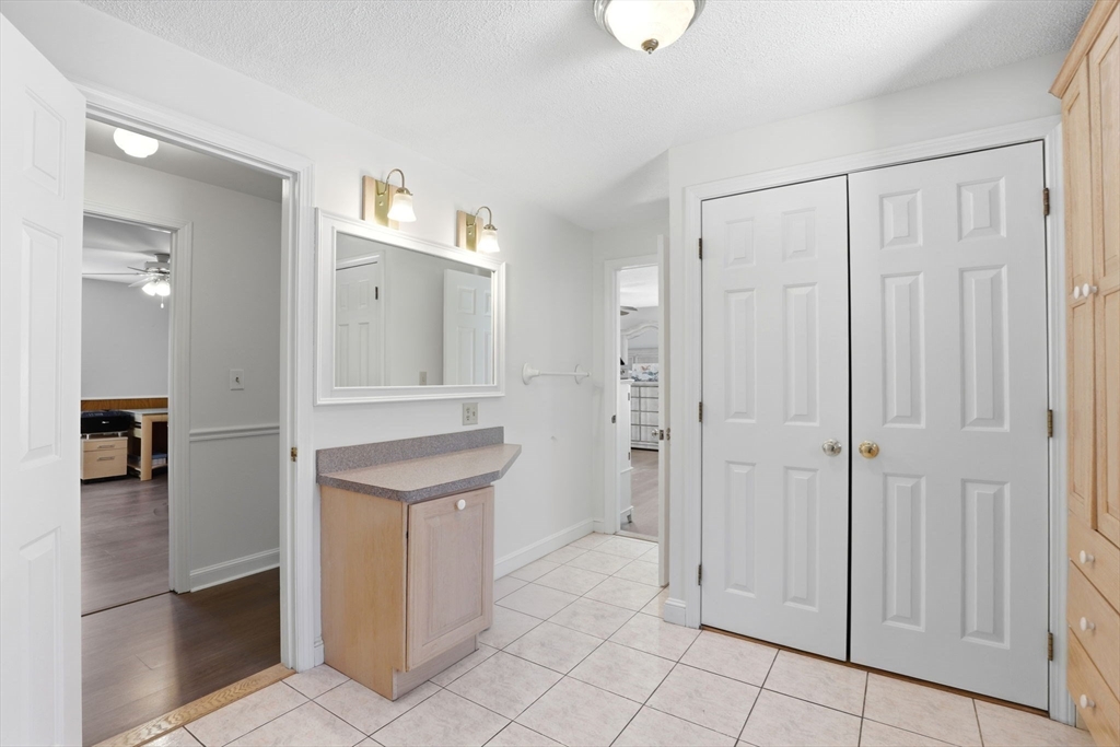 40 Fosdick Road Carver, MA 02330 - Photo 20 of 27 wooden floor with white cabinets and window