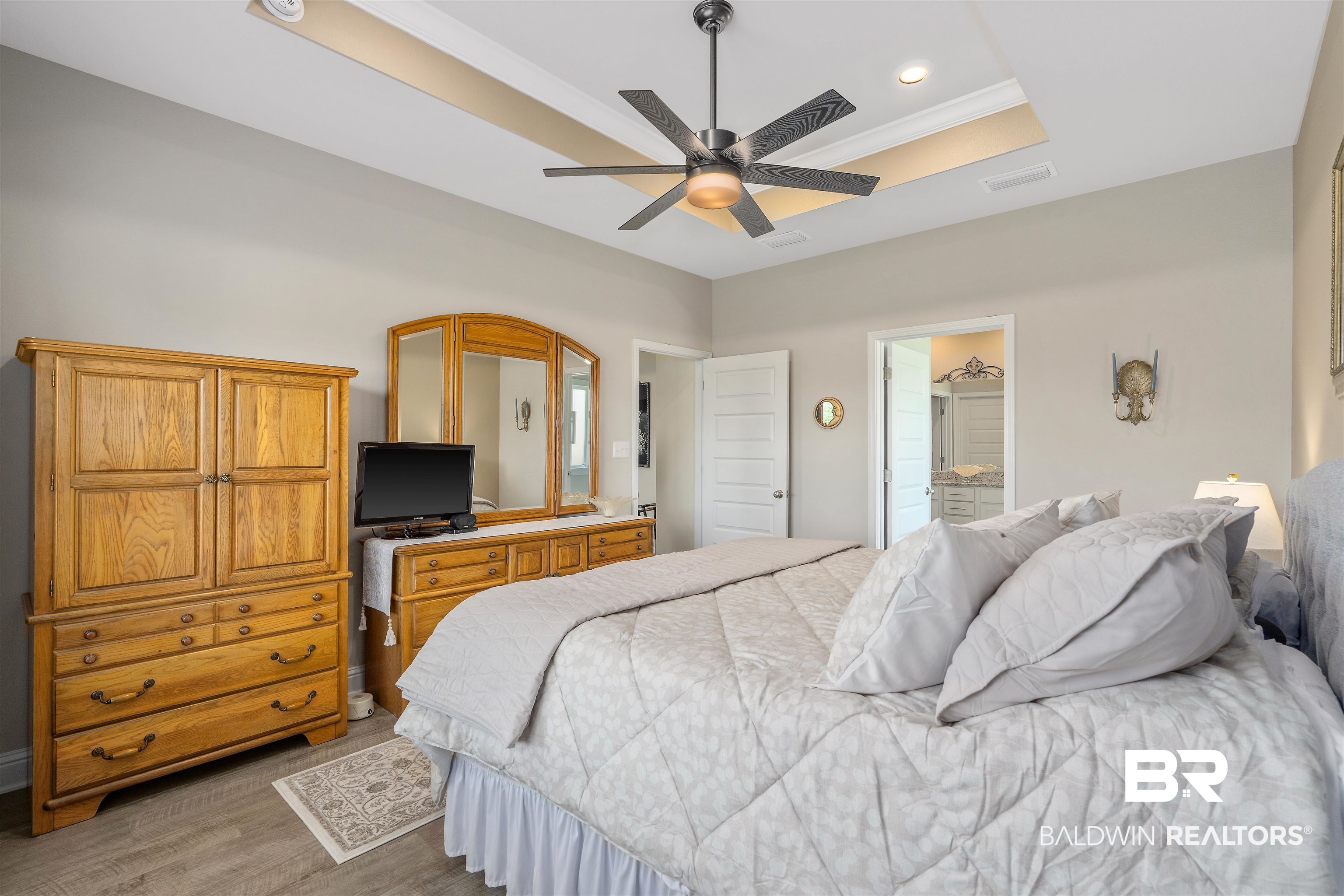 24593 Slater Mill Road Daphne, AL 36526 - Photo 17 of 32 Bedroom with a raised ceiling, wood finished floors, recessed lighting, ensuite bathroom, and a ceiling fan