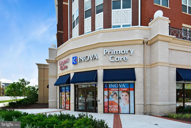 a view of a building with retail shops and traffic signal