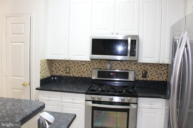 a kitchen with a stove and a microwave