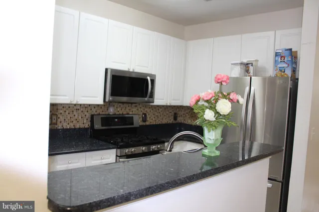 a bathroom with a sink a faucet and a granite counter tops